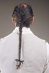 back of model's head showing long braided hair