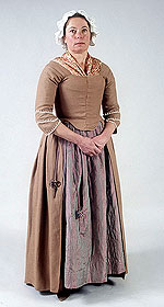 model wearing warm brown bodice and skirt over irredescent pinkish petticoat