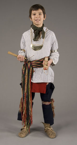 boy wearing striped cotten shirt, colorful sash, blue leggings and moccasins
