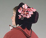 side view of bonnet showing pink artificial flowers